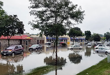 many cars stuck in a flooded parking lot