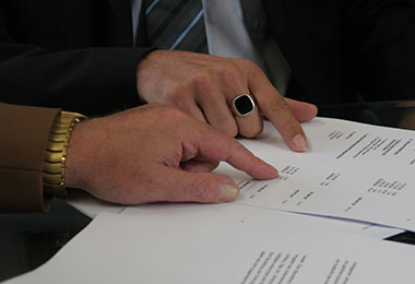 man and woman pointing at paperwork as they fill it out