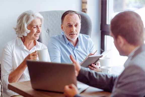 an older couple consulting with an attorney